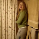 A girl is video-recorded by her friends as she pees while sitting on a toilet.